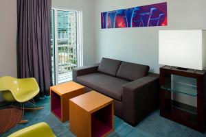 a living room with a couch and a table at Aloft by Marriott Miami - Brickell in Miami