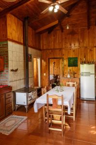 a kitchen and dining room with a table and a stove at Casa de la Guayubira in El Soberbio