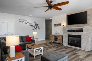 a living room with a fireplace and a flat screen tv at Coconuts RV Resort in Gravois Mills