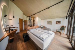 a bedroom with a bed and a desk and a chair at Boutique-Hotel LARTOR in Unterammergau