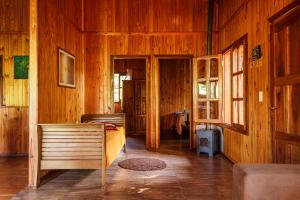 a bedroom with a bed in a wooden room at Casa de la Guayubira in El Soberbio +51 photos