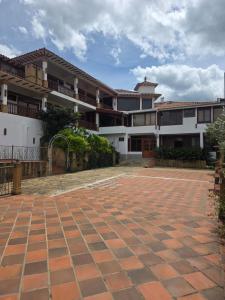a courtyard in front of a building at Hotel Puente Piedra in Villa de Leyva