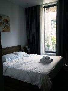 a bedroom with a bed with a stuffed animal on it at NÚP Homestay Huế in Thôn Dương Xuân Hạ