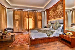 a bedroom with a large bed and a table at The Forest Castle Resort in Pahalgām +8 photos