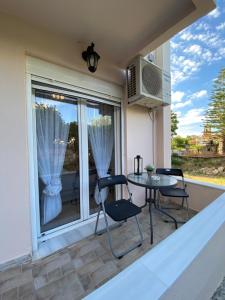 a patio with a table and chairs and a window at MarSia Apartment in Chios +53 photos