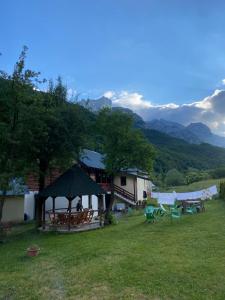 a house with a gazebo and tables and chairs at Guest house Niko in Çerem