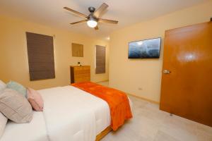 a bedroom with a bed and a ceiling fan at Santa Cruz Suites in Lower South Hill