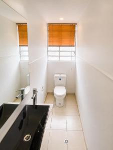 a small bathroom with a toilet and a sink at Casa Corferias in Bogotá
