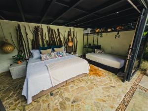 a bedroom with a bed and a couch at Element Quindío in Boquía
