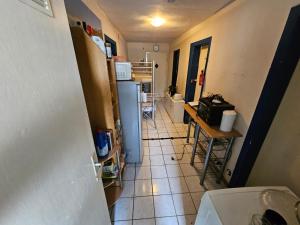 a small kitchen with a refrigerator and a table at SCHLAFGELEGENHEiT in Essen