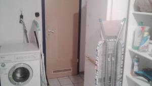 a laundry room with a washing machine and a washer at SCHLAFGELEGENHEiT in Essen