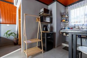 a kitchen with a ladder in the corner of a room at Chalé Aliança in Poços de Caldas