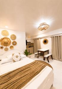 a bedroom with a large bed and a table at A&H Homestay in Catangnan +10 photos
