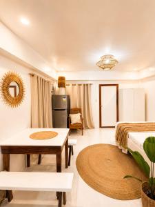 a large living room with a bed and a table at A&H Homestay in Catangnan