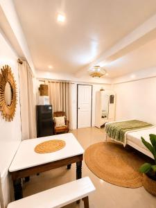 a living room with a bed and a table at A&H Homestay in Catangnan