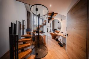 a bathroom with a wooden staircase and a mirror at Boutique-Hotel LARTOR in Unterammergau +59 photos