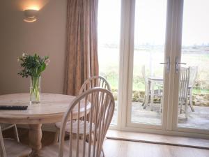 a dining room with a table and chairs and a window at Highfield in Petworth