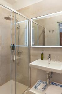 a bathroom with a shower and a sink and a mirror at Hospedium Hotel Lleida in Graus +39 photos