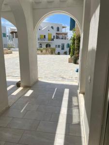 an archway in a building with a view of a courtyard at Southern Nights in Gjilek +6 photos
