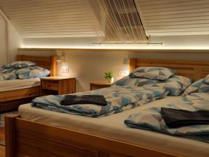 a bedroom with two beds and two night stands at Balaton Chillhouse in Balatonakarattya