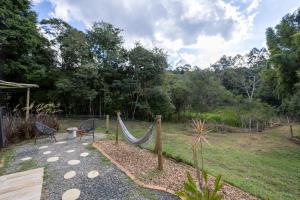 a hammock in the middle of a garden at Chalé Aliança in Poços de Caldas