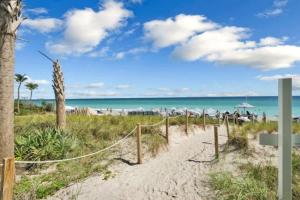 a path to the beach with palm trees and the ocean at Charming Studio by the Ocean Beach Service in Hallandale Beach