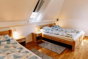 a bedroom with two beds and a window at Balaton Chillhouse in Balatonakarattya
