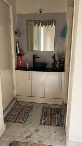 a bathroom with a sink and a mirror at PR PREMIUMSUITs in Surūrnagar