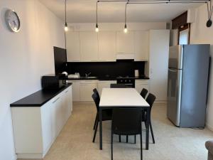 a kitchen with a table and a refrigerator at Appartamenti HERA in Lazise