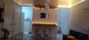 a living room with a table and some lights on the wall at Espaço Jk in Diamantina