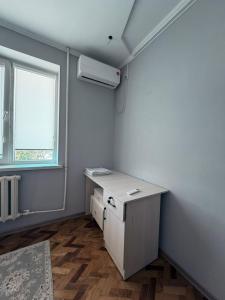 an empty room with a desk and a window at Nomad Guest House Osh in Osh
