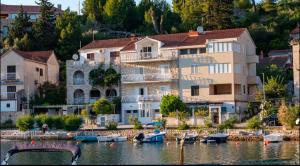 a group of houses and boats on a body of water at Villa Aquiterra Bobovisca in Bobovišća