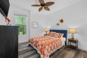 a bedroom with a bed and a ceiling fan at Coconuts RV Resort in Gravois Mills +69 photos