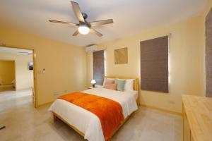 a bedroom with a bed and a ceiling fan at Santa Cruz Suites in Lower South Hill