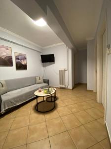 a living room with a couch and a table at MarSia Apartment in Chios