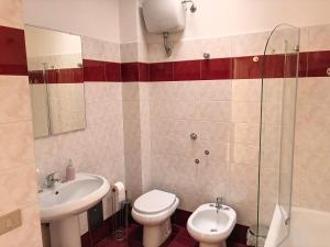 a bathroom with a toilet and a sink at Il Cavaliere in Praia a Mare