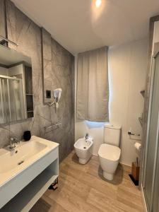 a bathroom with a toilet and a sink at Camping Delfino in Albenga +44 photos