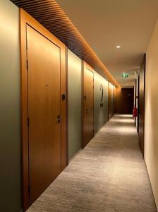 a hallway with wooden doors and a long aisle at Oru Park & Sea Apartment in Tallinn