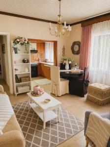 a living room with a table and a kitchen at Kikas Stone House in Ávaton