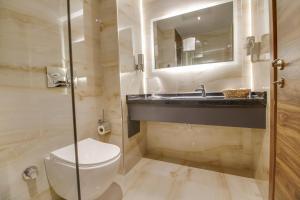 a bathroom with a toilet and a sink at Newway Otel in Kayseri +14 photos