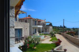 a villa with a view of the garden at Elements Villas in Paleros