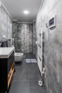 a bathroom with a shower and a toilet and a sink at Apartment Grof Janko - Luxury in the Center - TERRACE & FREE PARKING in Karlovac +19 photos