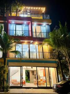 a large building with a lot of windows and chairs at Flamingos Hải Tiến LUXURY view biển tầng cao và Biệt thự 4pn in Thanh Hóa