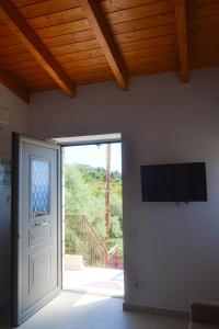 a room with a door and a television on the wall at Elements Villas in Paleros