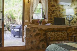 a bedroom with a bed and a view of a patio at El Encinar de Arta in Artá