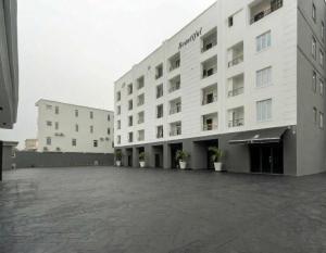 a large white building with a large parking lot at The District Lekki by GCI in Lekki Phase 1