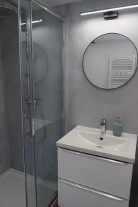 a bathroom with a sink and a mirror at Domki Paradise Charzykowy in Charzykowy +35 photos