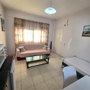 a living room with a couch and a table at Soula appartments in Makry Gialos