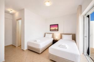 a bedroom with two beds and a window at Villa Peach in Katelios +13 photos
