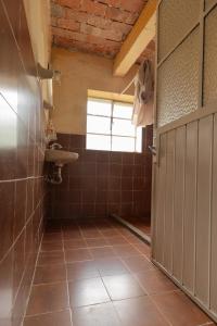 a bathroom with a sink and a toilet and a door at Hospedaje Las Palmas By GEstores in Huasca de Ocampo +165 photos